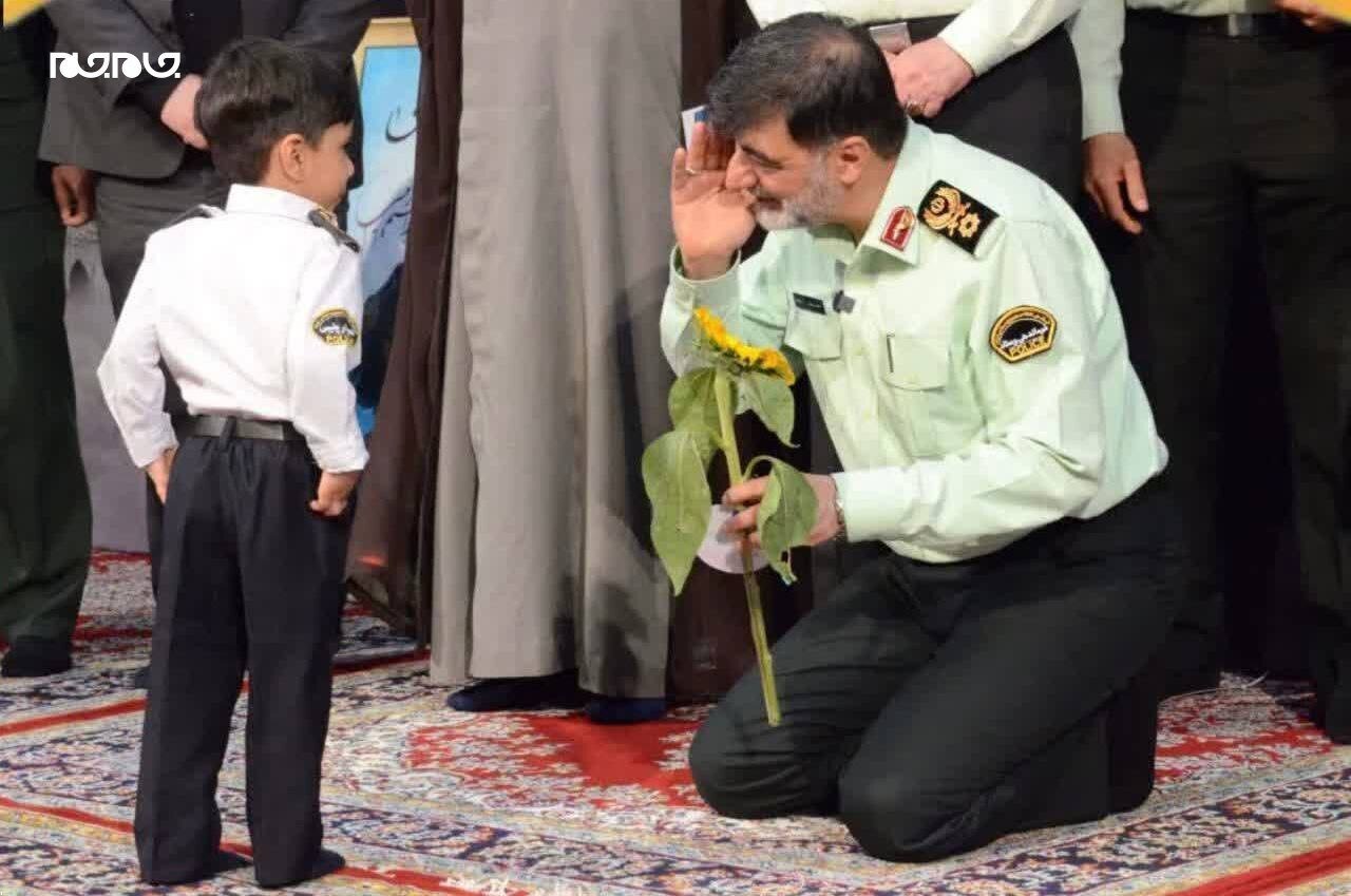 عکس | ادای احترام سردار رادان به فرزند شهید باغبان‌زاده